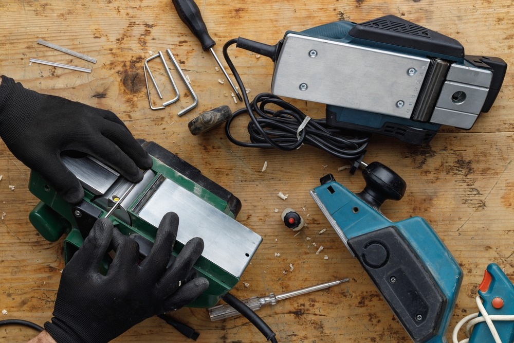 a man in gloves dismantling a tool